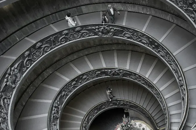 people walking on spiral staircase